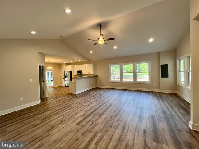 a view of a kitchen with a sink and a refrigerator