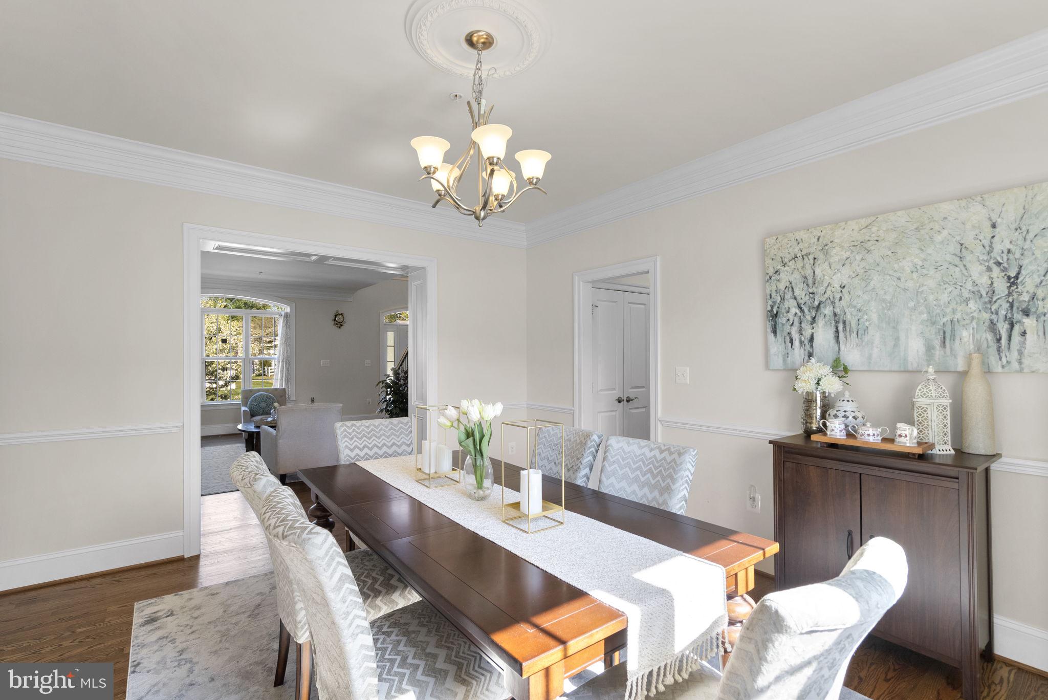 22403 Newcut Road Clarksburg, MD 20871 - Photo 19 of 78 a view of a dining room with furniture wooden floor and chandelier