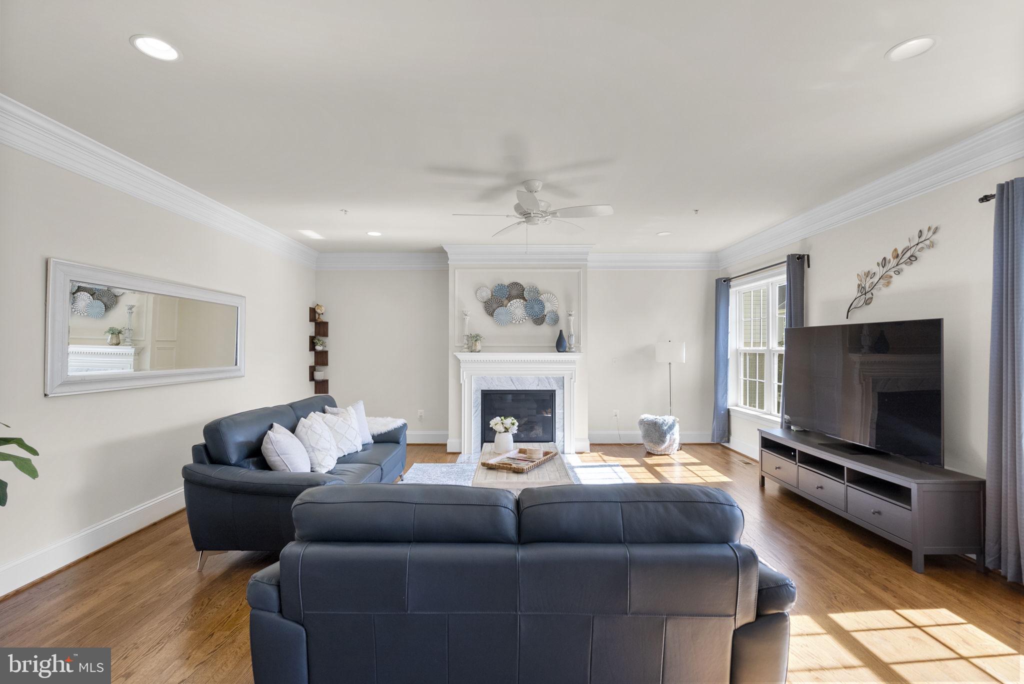 22403 Newcut Road Clarksburg, MD 20871 - Photo 27 of 78 a living room with furniture a flat screen tv and a fireplace