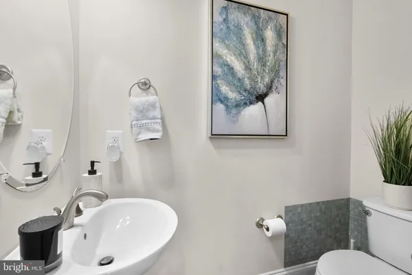 a bathroom with a granite countertop shower a sink and a mirror