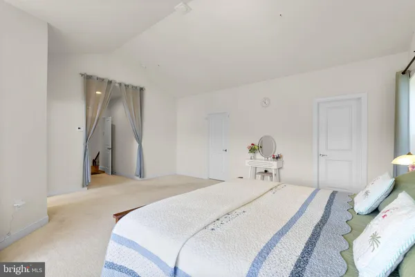 a bedroom with a bed and a table