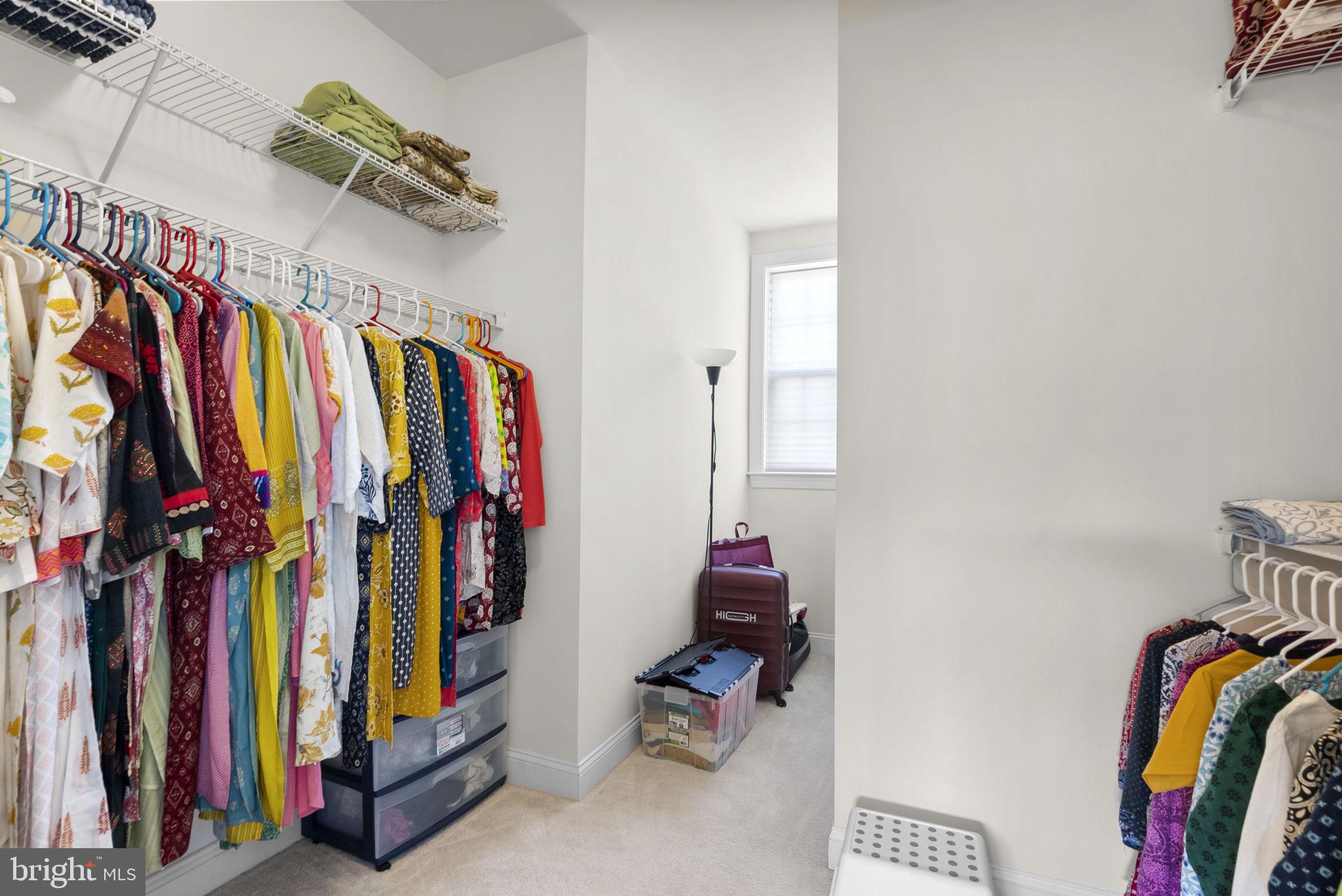 22403 Newcut Road Clarksburg, MD 20871 - Photo 40 of 78 a view of walk in closet with clothes and shoes