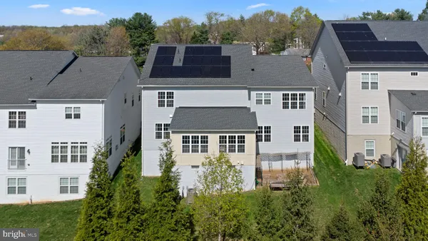 an aerial view of a house with a yard in front of it