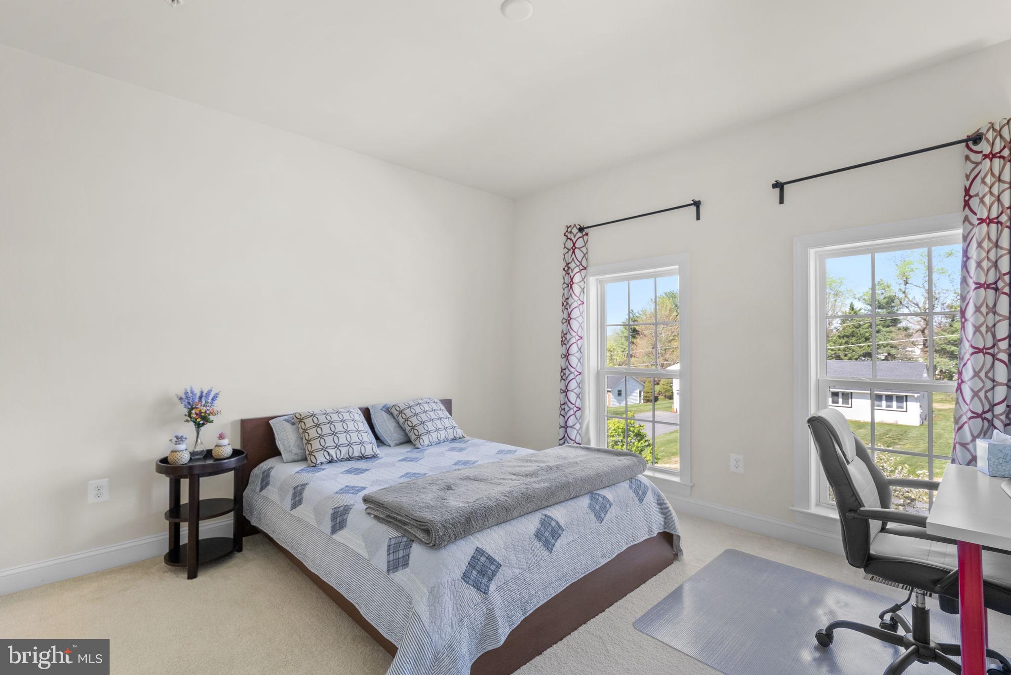 22403 Newcut Road Clarksburg, MD 20871 - Photo 45 of 78 a bedroom with a bed a table and windows