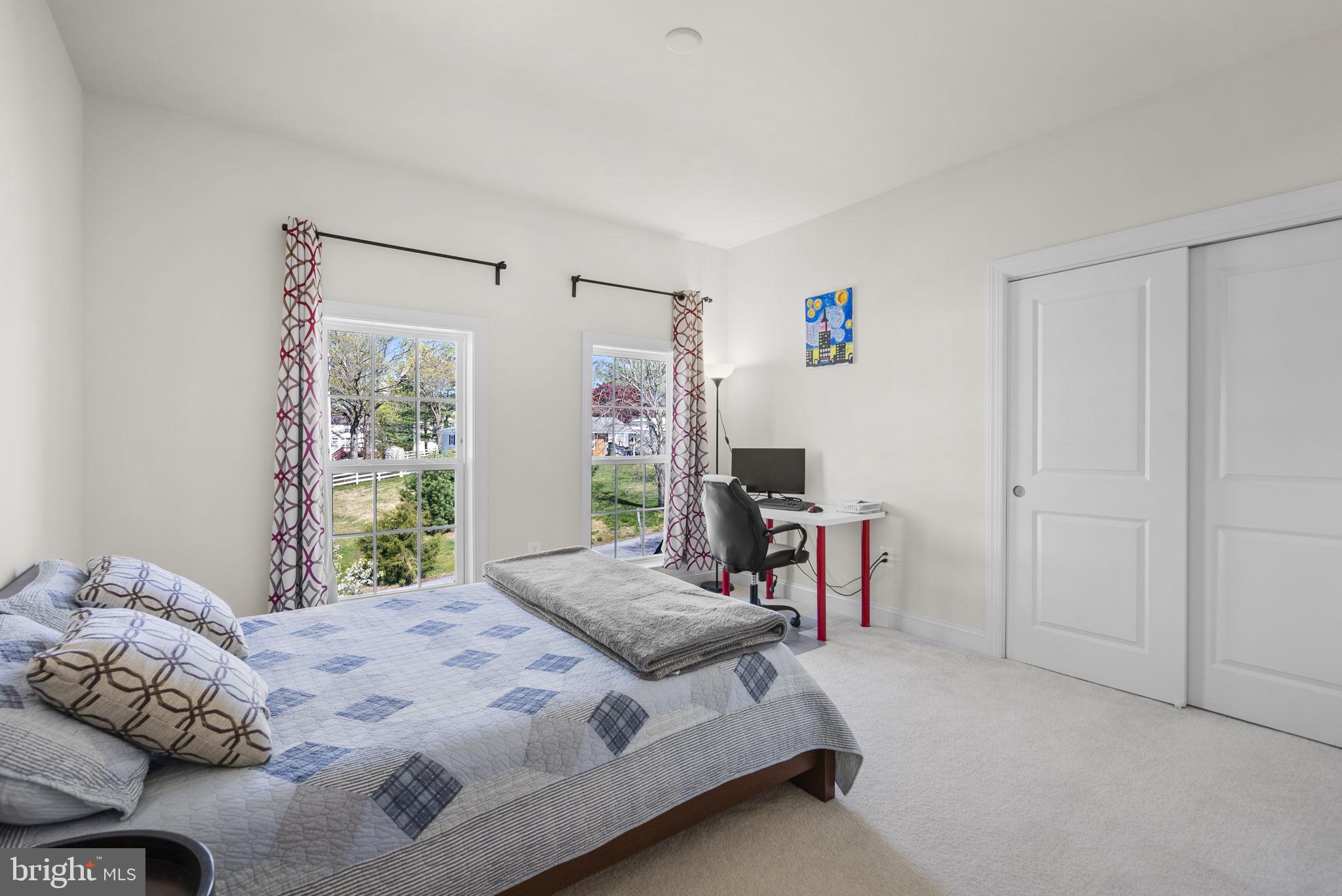 22403 Newcut Road Clarksburg, MD 20871 - Photo 46 of 78 a bedroom with a bed and a table