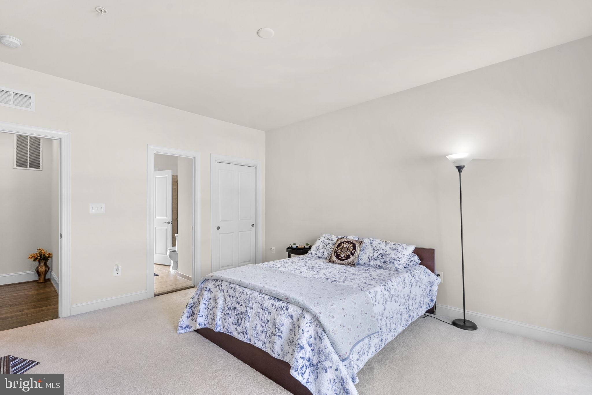 22403 Newcut Road Clarksburg, MD 20871 - Photo 47 of 78 a bedroom with a bed and a night stand