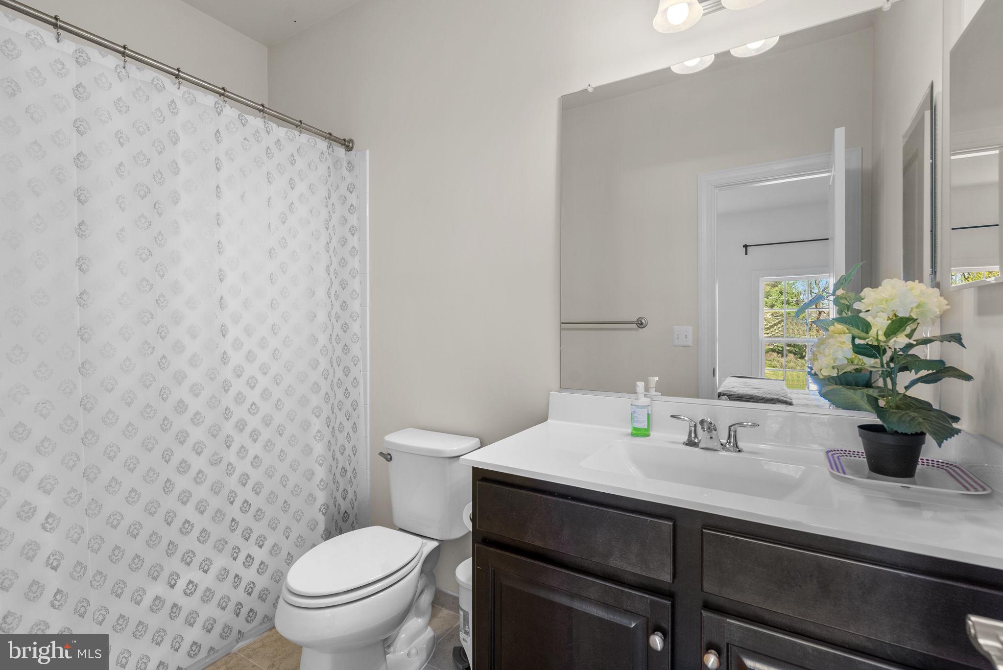 22403 Newcut Road Clarksburg, MD 20871 - Photo 55 of 78 a bathroom with a sink a toilet and a mirror