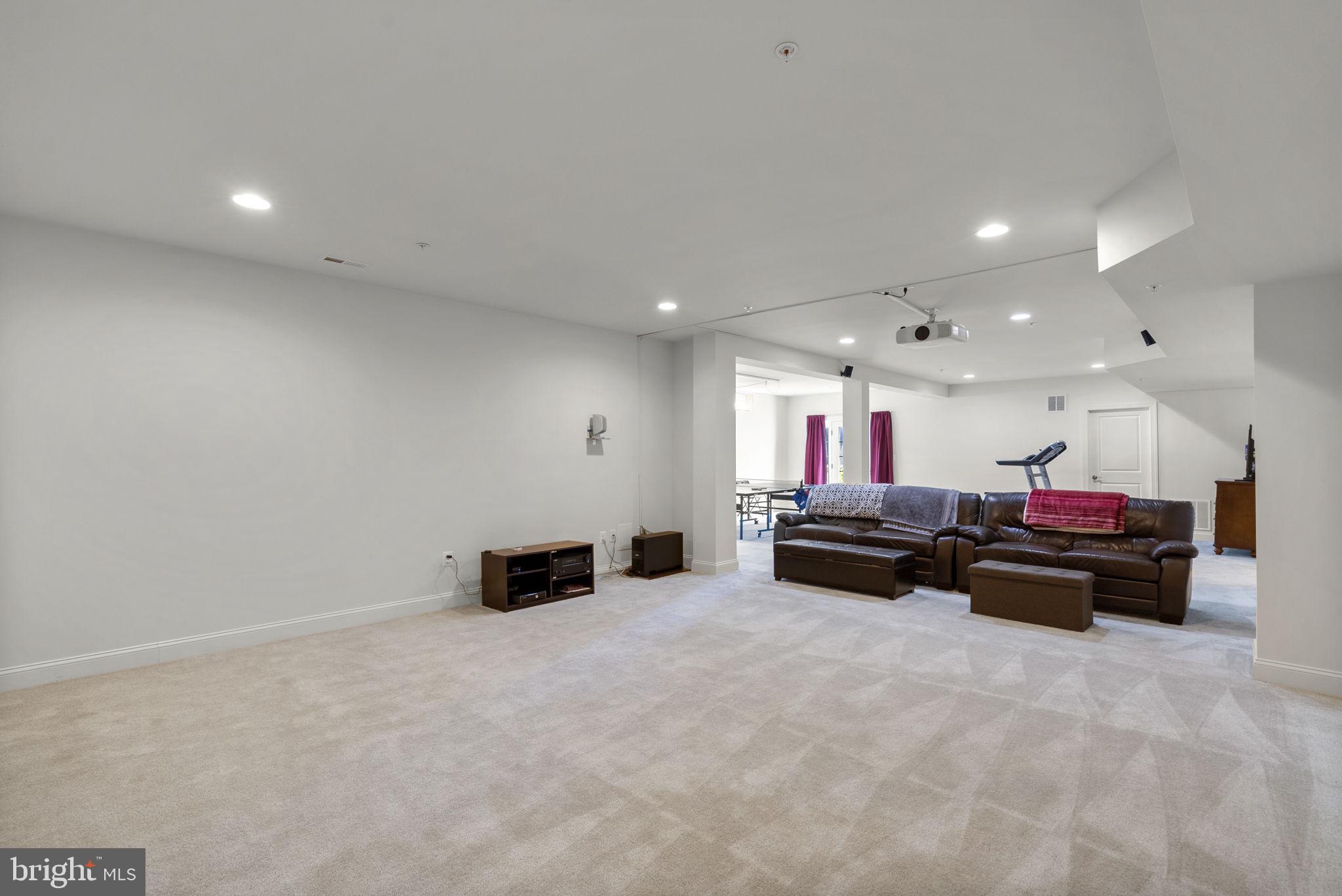 22403 Newcut Road Clarksburg, MD 20871 - Photo 60 of 78 a living room with furniture and a flat screen tv