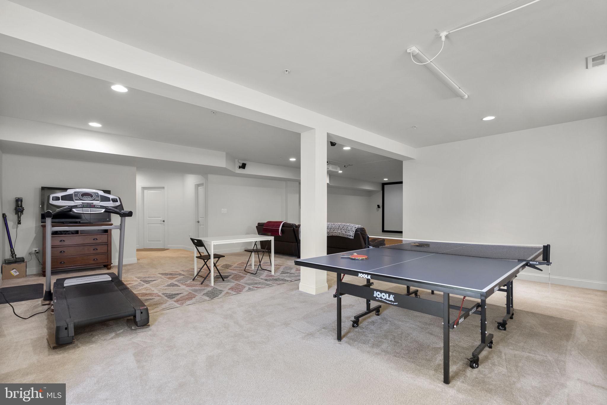 22403 Newcut Road Clarksburg, MD 20871 - Photo 61 of 78 a room with gym equipment and a table