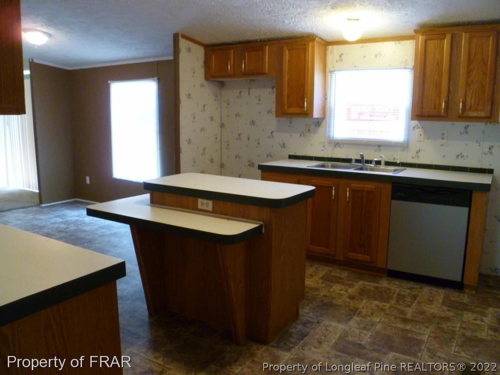 903 Poole Road Raeford, NC 28376 - Photo 13 of 27 a kitchen with sink cabinets and window