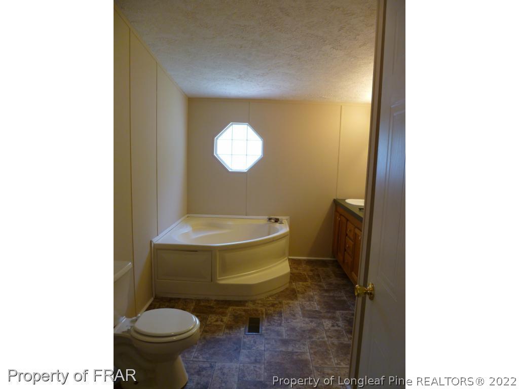 903 Poole Road Raeford, NC 28376 - Photo 17 of 27 a bathroom with a toilet and a sink