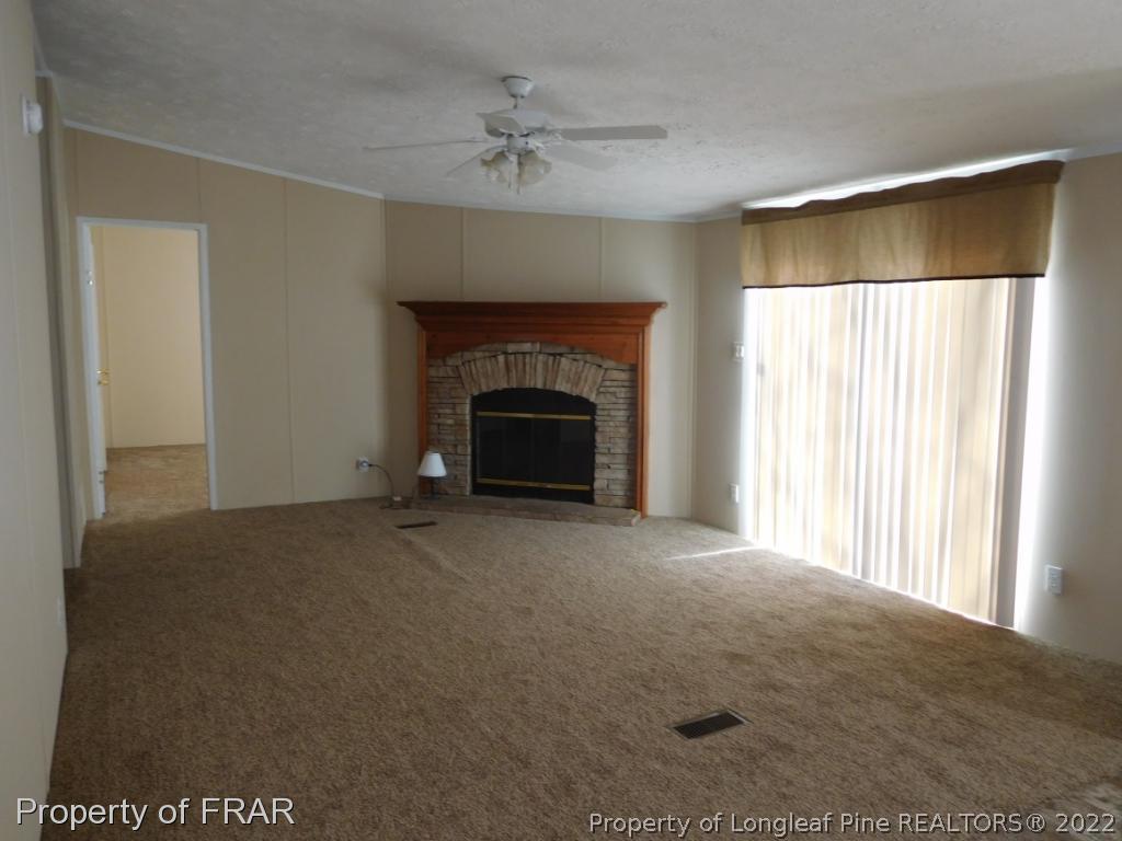 903 Poole Road Raeford, NC 28376 - Photo 5 of 27 a view of empty room with a fireplace