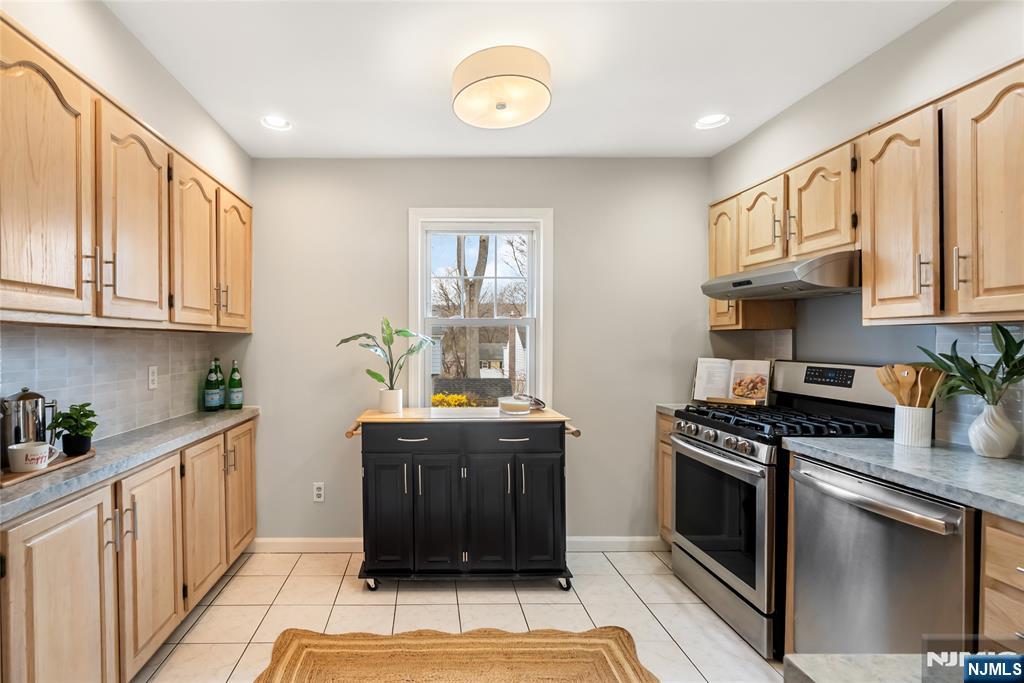 5 Northview Terrace Maplewood, NJ 07040 - Photo 12 of 47 a kitchen with stainless steel appliances granite countertop a stove a sink and a microwave