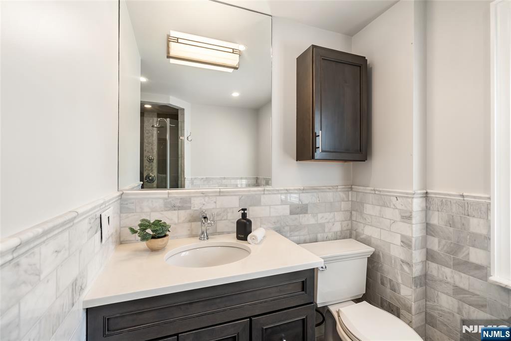 5 Northview Terrace Maplewood, NJ 07040 - Photo 24 of 47 a bathroom with a toilet sink and mirror