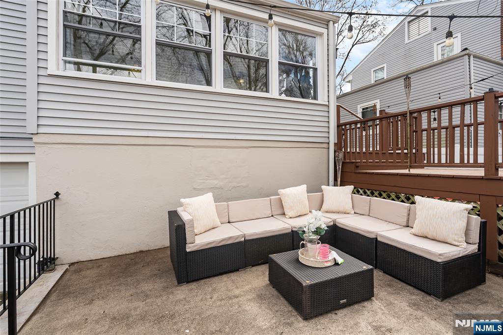 5 Northview Terrace Maplewood, NJ 07040 - Photo 38 of 47 a view of a patio with couches table and chairs with wooden floor