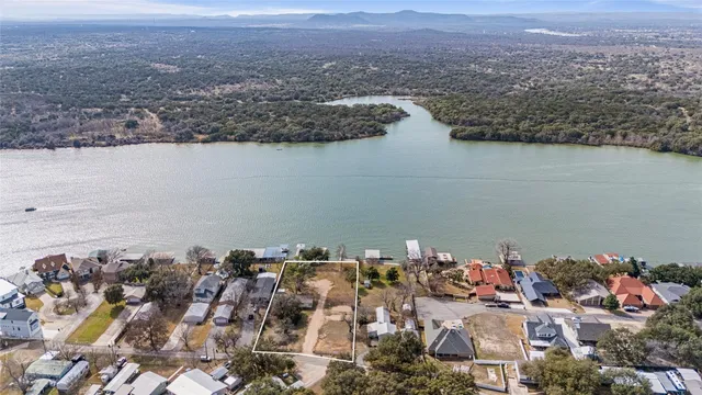 an aerial view of a house with a lake view