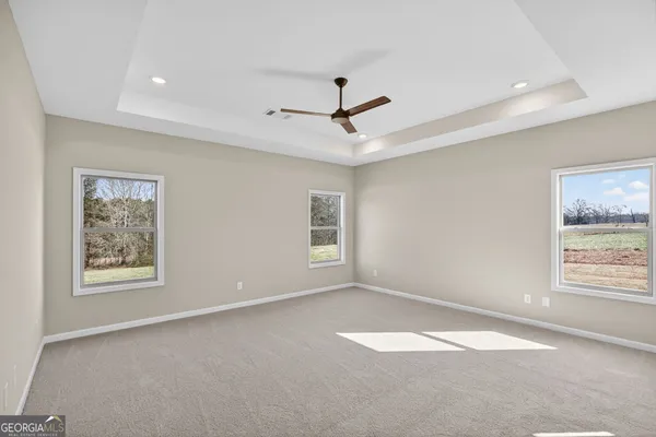a bedroom with a large bed and a ceiling fan