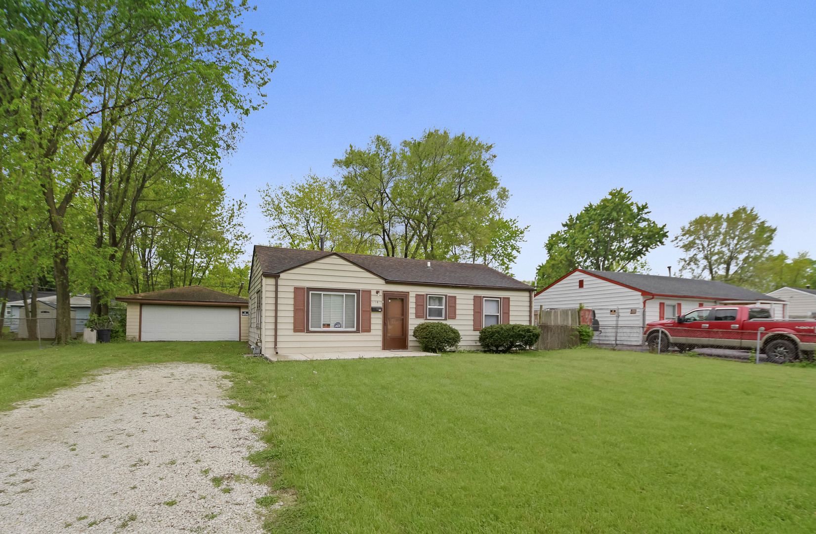 116 Louis Road Joliet, IL 60433 - Photo 1 of 12 a front view of a house with a yard and trees