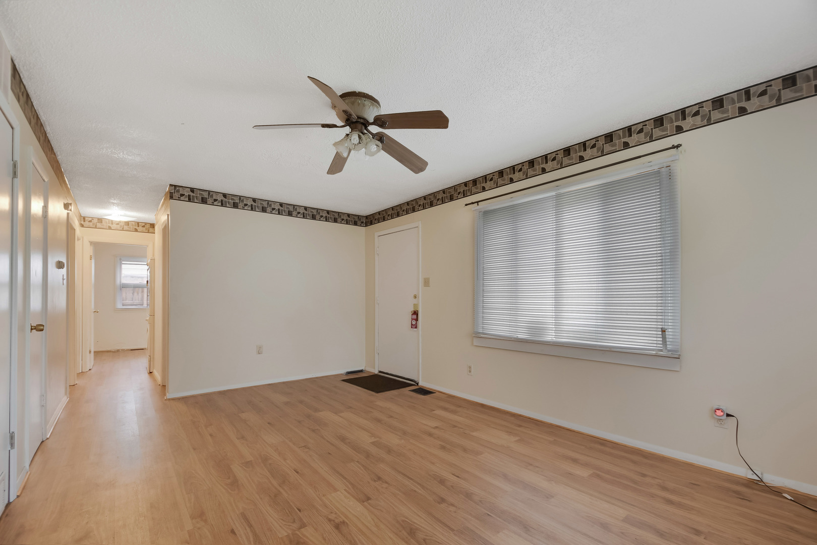 116 Louis Road Joliet, IL 60433 - Photo 2 of 12 a view of empty room with wooden floor and fan