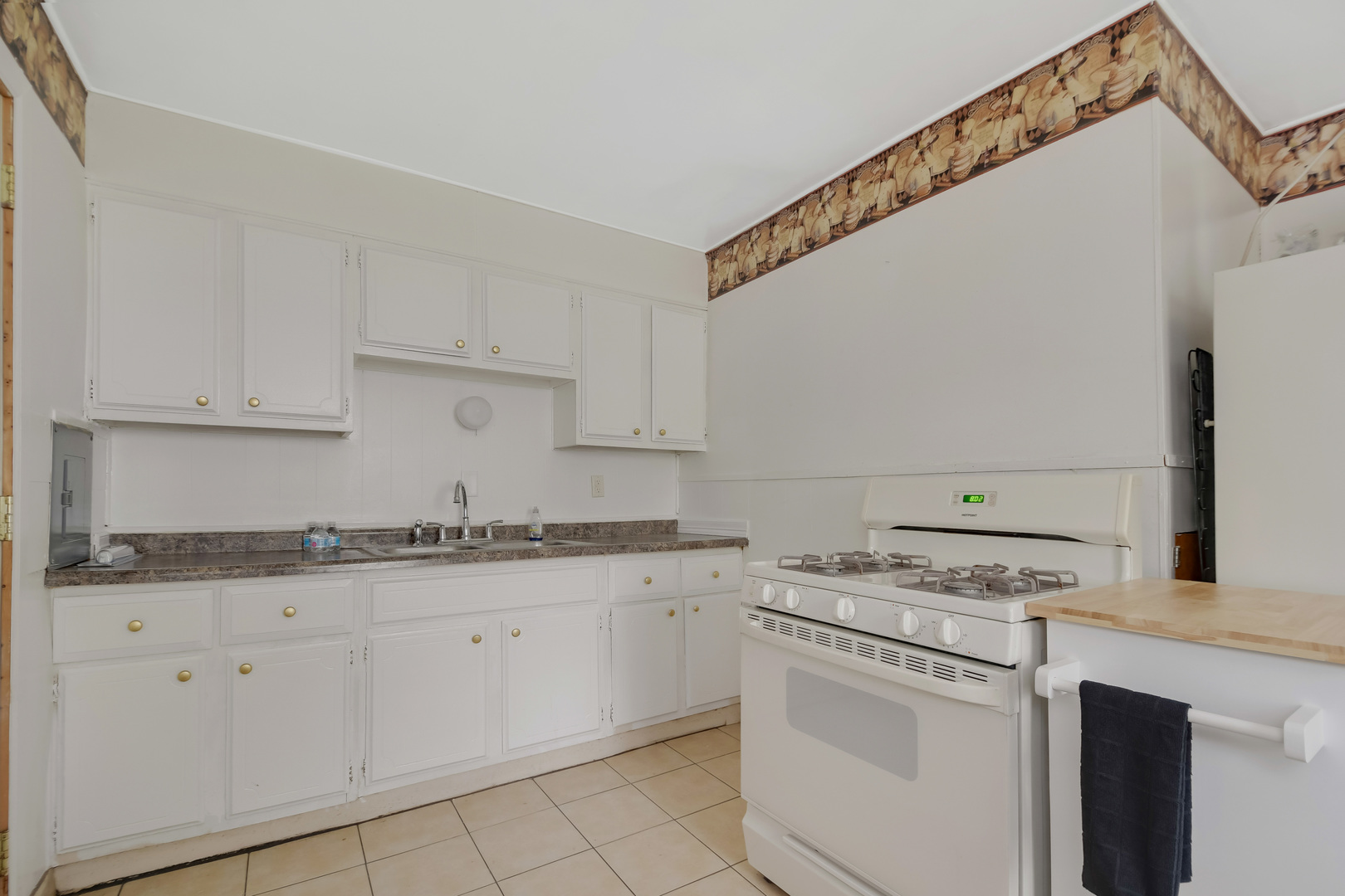116 Louis Road Joliet, IL 60433 - Photo 4 of 12 a kitchen with granite countertop white cabinets and white appliances