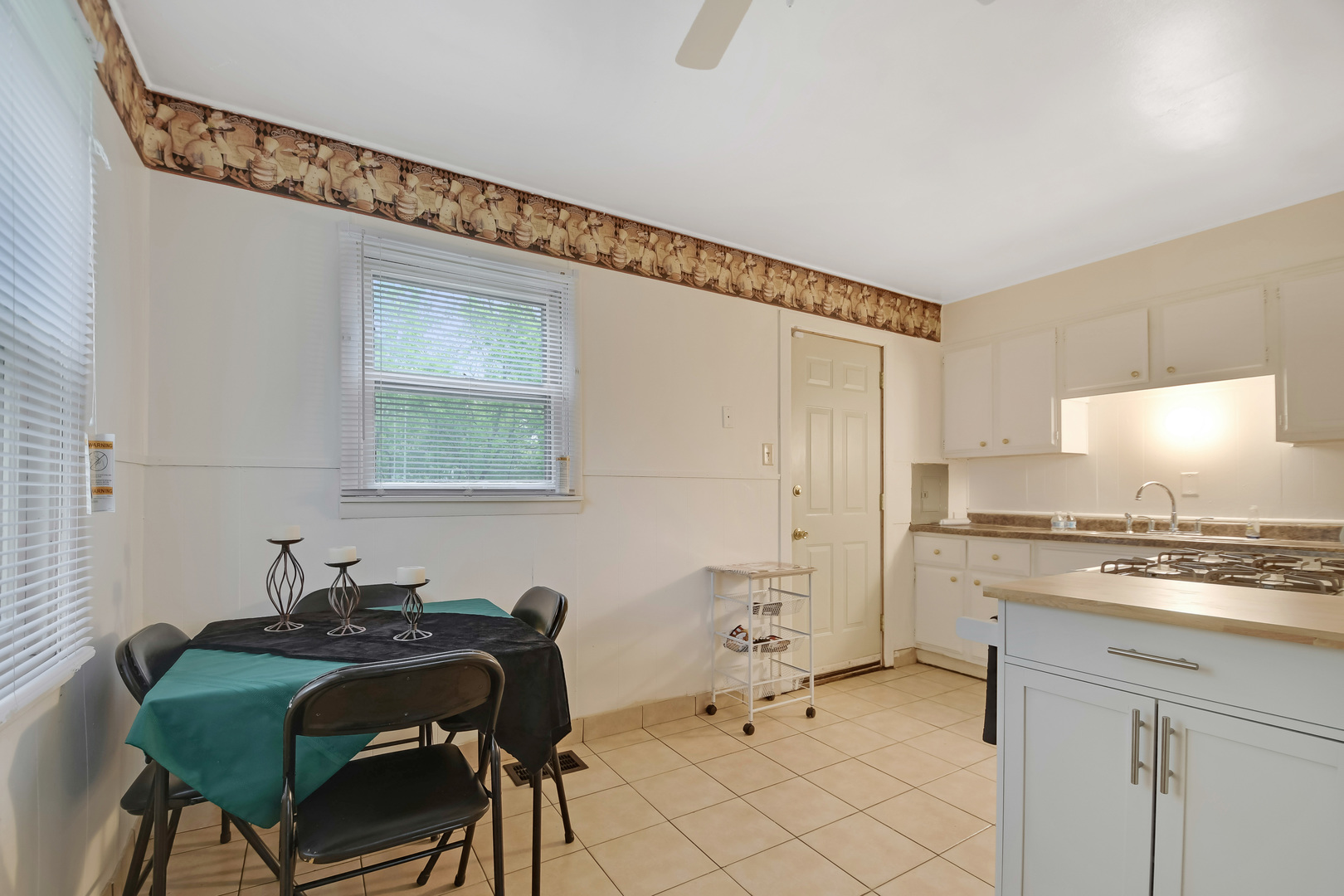 116 Louis Road Joliet, IL 60433 - Photo 5 of 12 a kitchen with stainless steel appliances a stove a sink and a refrigerator