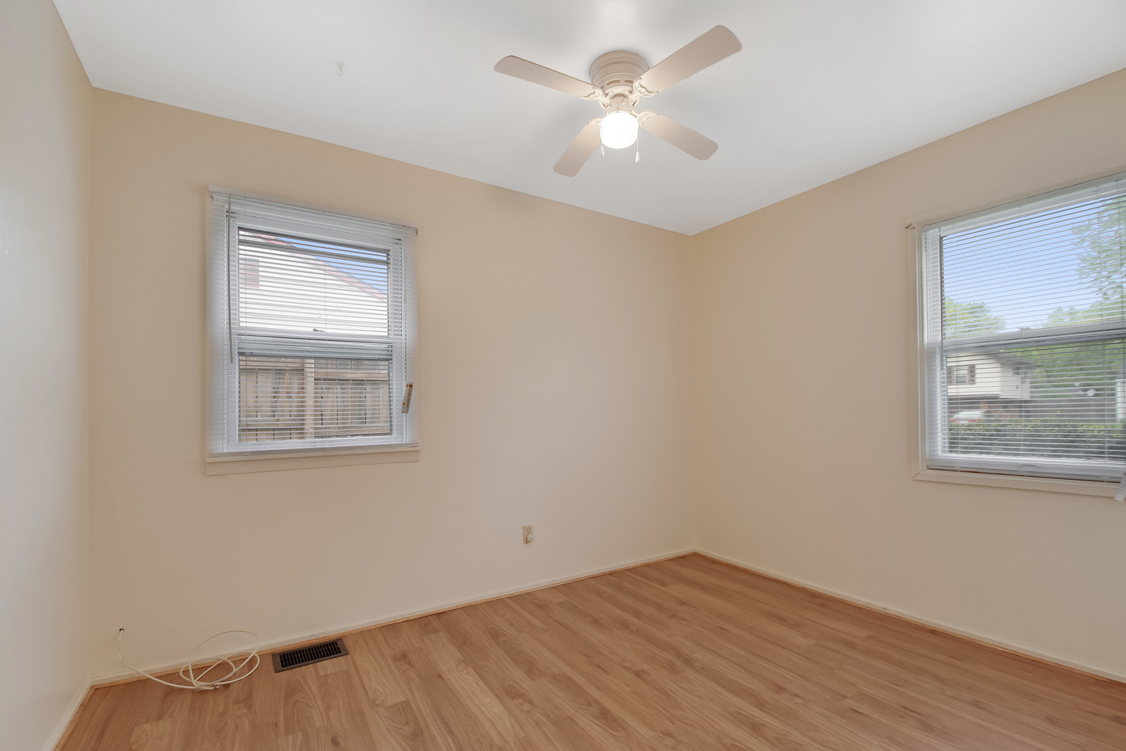 116 Louis Road Joliet, IL 60433 - Photo 6 of 12 a view of empty room with wooden floor and fan