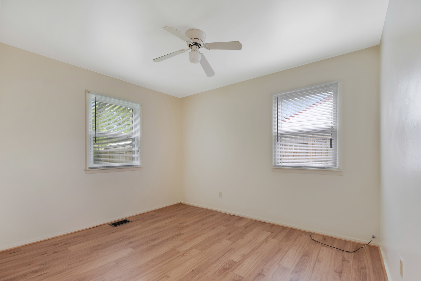 116 Louis Road Joliet, IL 60433 - Photo 7 of 12 a view of an empty room with a window and wooden floor