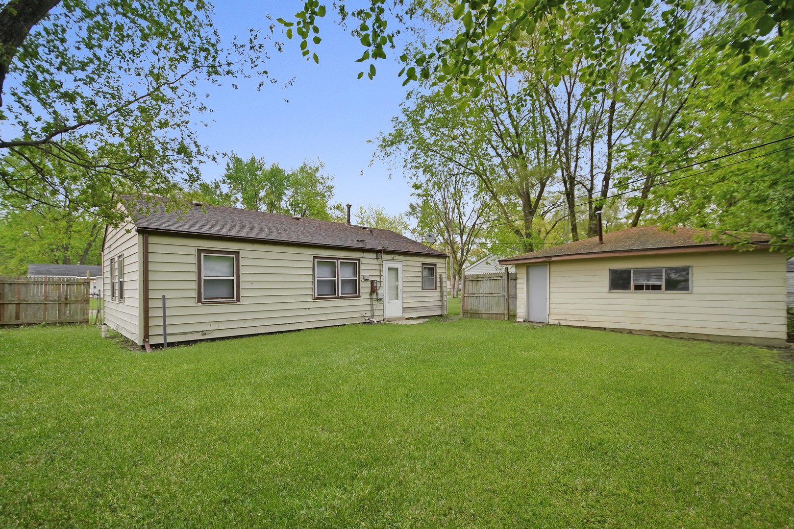 116 Louis Road Joliet, IL 60433 - Photo 10 of 12 a backyard of a house with table and chairs