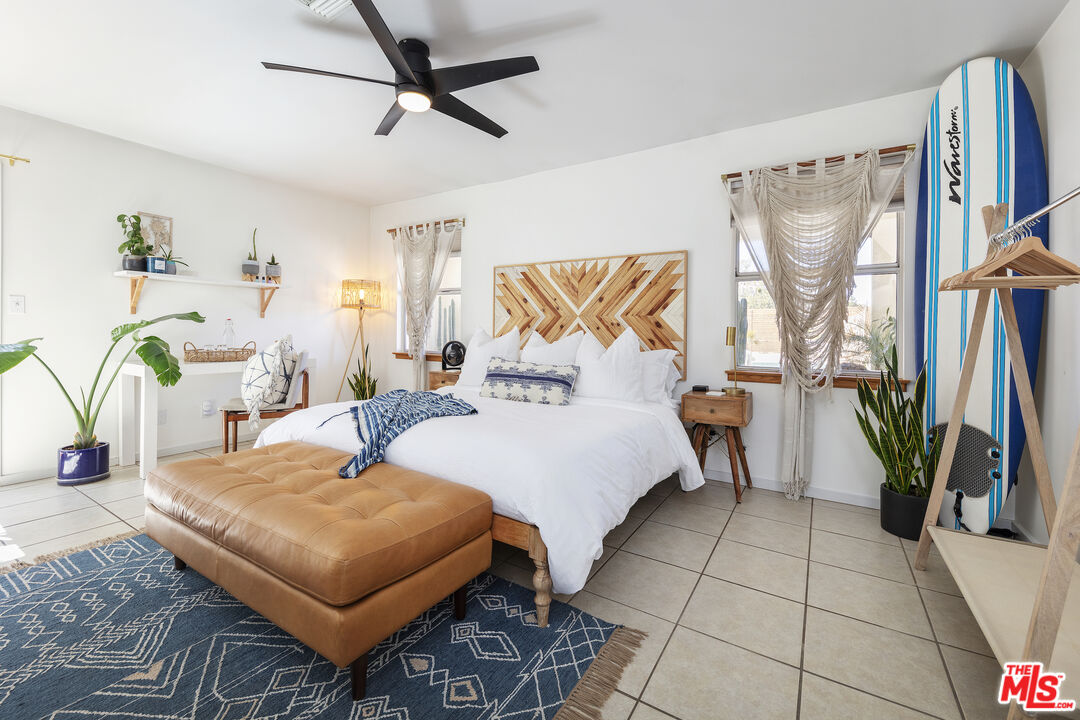 56434 Cobalt Road Yucca Valley, CA 92284 - Photo 13 of 75 a bedroom with a bed a couch and a window