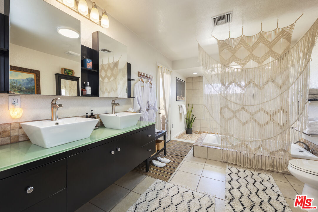 56434 Cobalt Road Yucca Valley, CA 92284 - Photo 15 of 75 a bathroom with a double vanity sink mirror and toilet