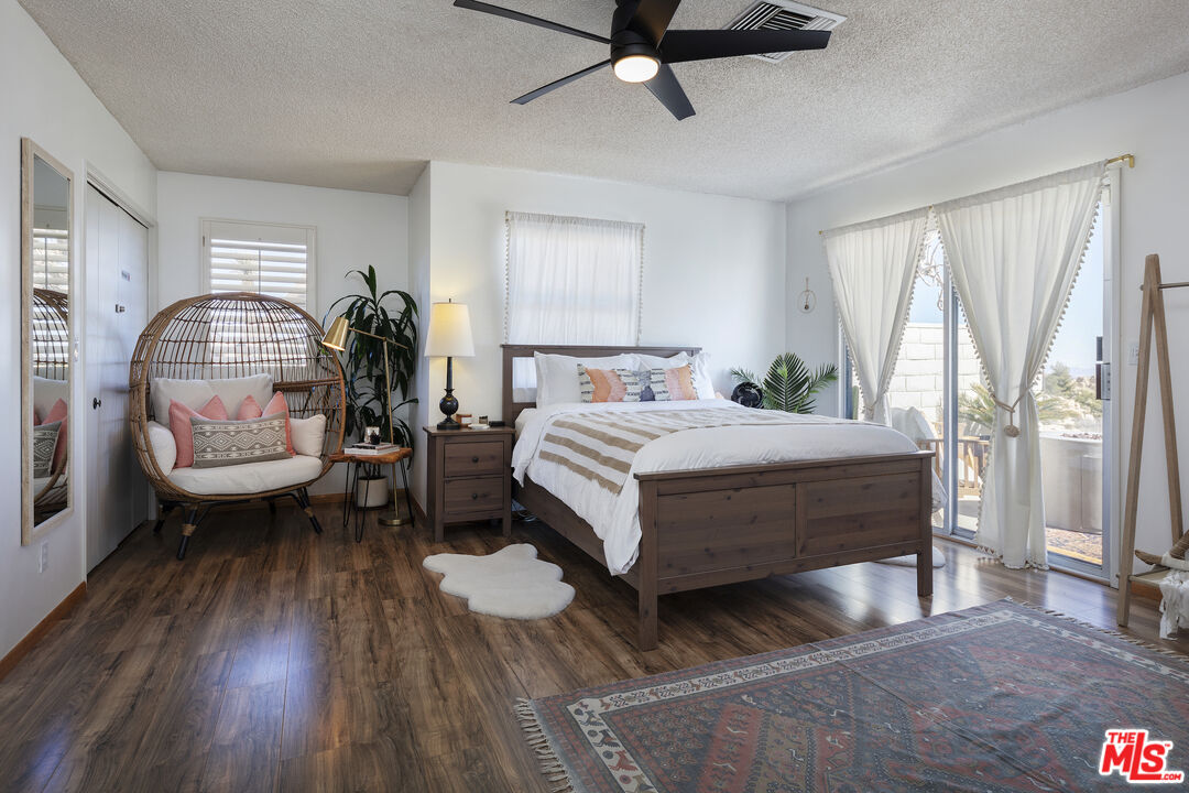 56434 Cobalt Road Yucca Valley, CA 92284 - Photo 18 of 75 a bedroom with a bed and a chandelier