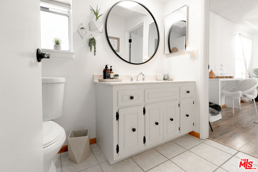 56434 Cobalt Road Yucca Valley, CA 92284 - Photo 29 of 75 a bathroom with a toilet a sink and mirror