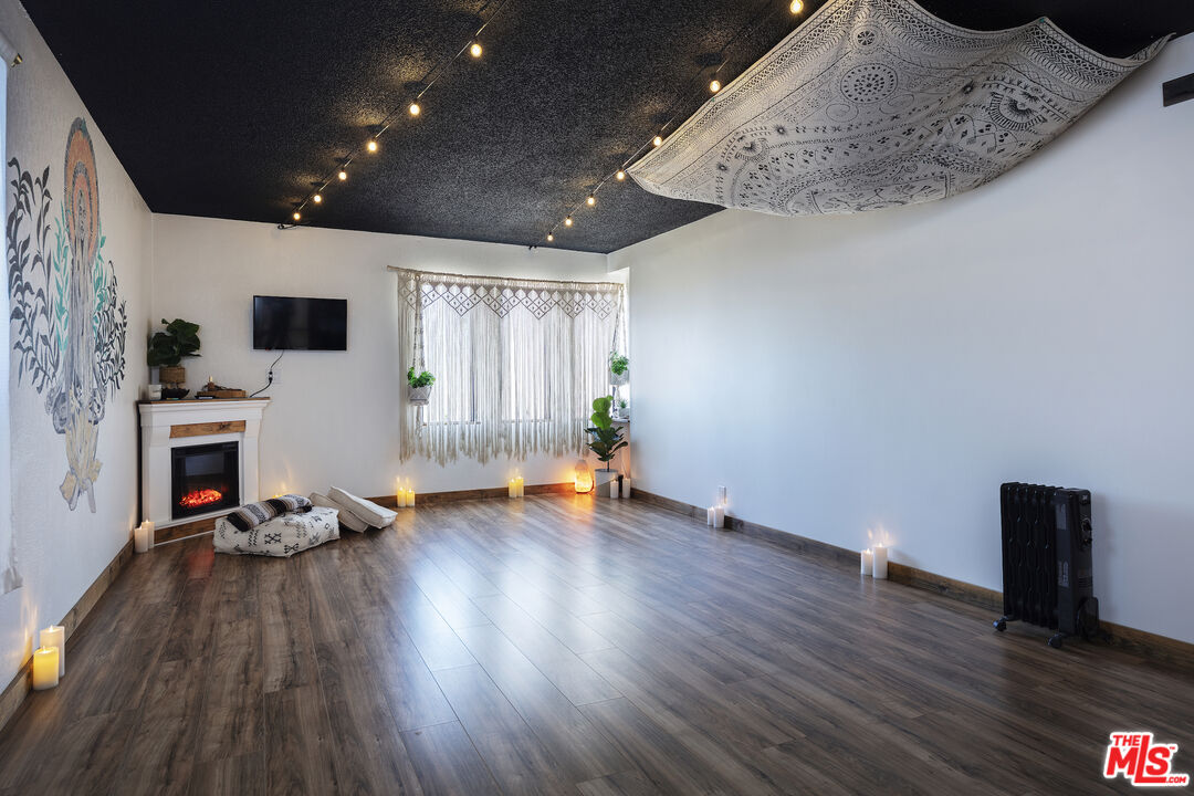 56434 Cobalt Road Yucca Valley, CA 92284 - Photo 32 of 75 a view of a livingroom with wooden floor and a fireplace