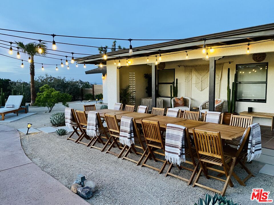 56434 Cobalt Road Yucca Valley, CA 92284 - Photo 59 of 75 a view of a patio with a dining table and chairs