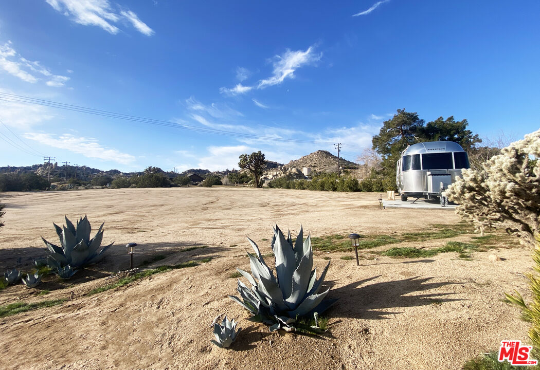 56434 Cobalt Road Yucca Valley, CA 92284 - Photo 69 of 75 a view of a lake with a house in the background