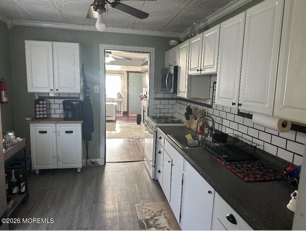 284 Washington Street Keyport, NJ 07735 - Photo 11 of 23 a kitchen with stainless steel appliances a sink stove and cabinets