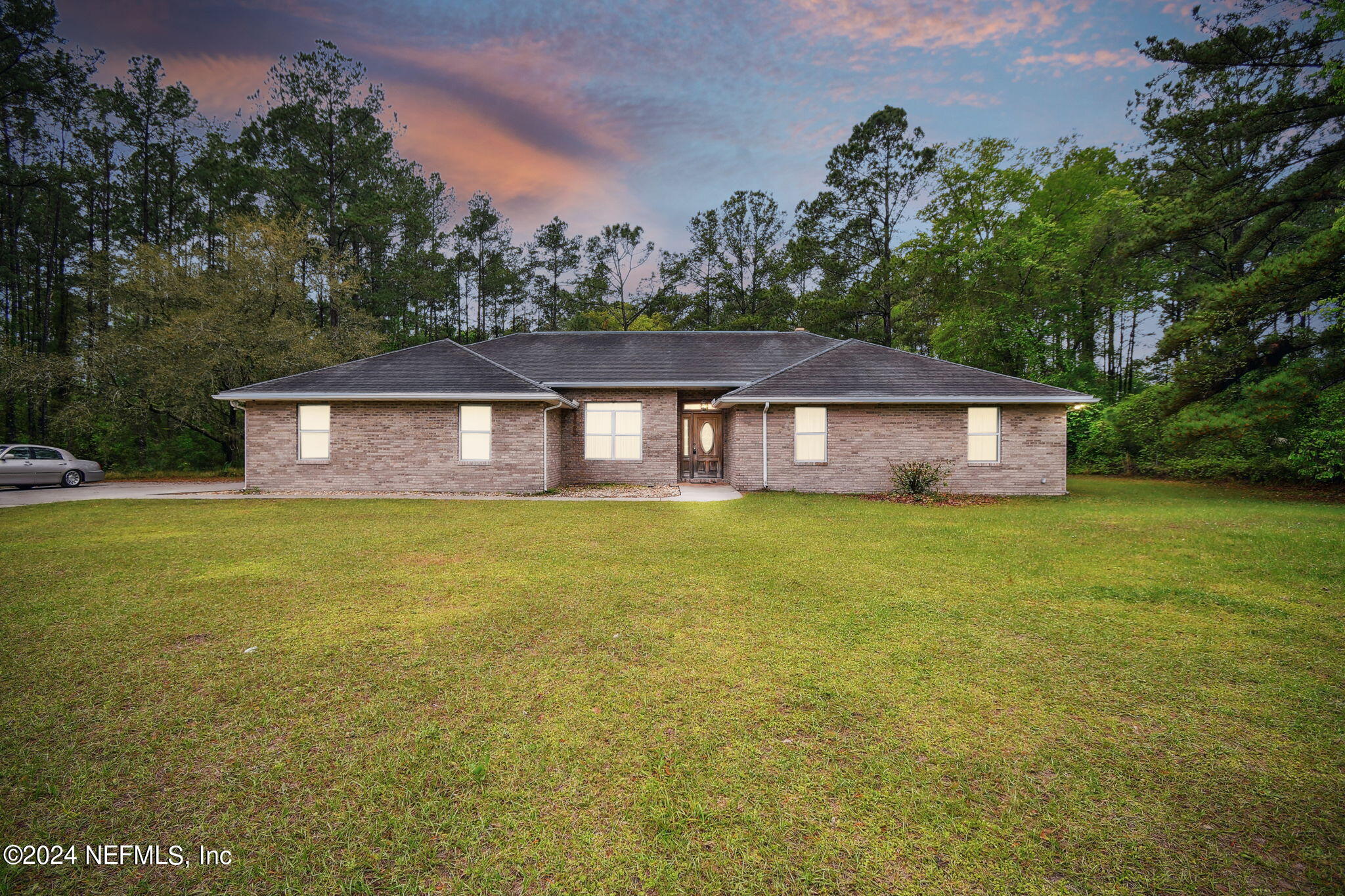 a front view of a house with a garden