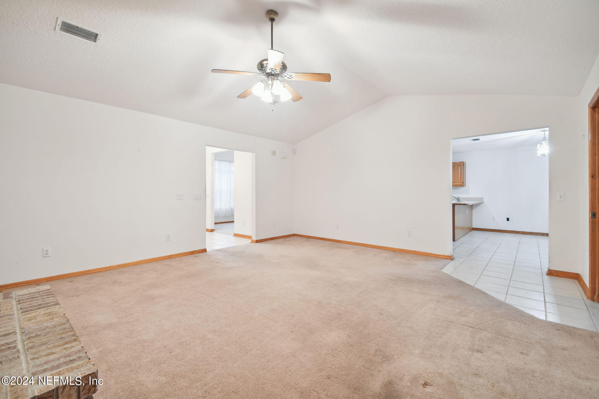 36068 J W Elliott Road Callahan, FL 32011 - Photo 12 of 54 an empty room with chandelier fan and windows