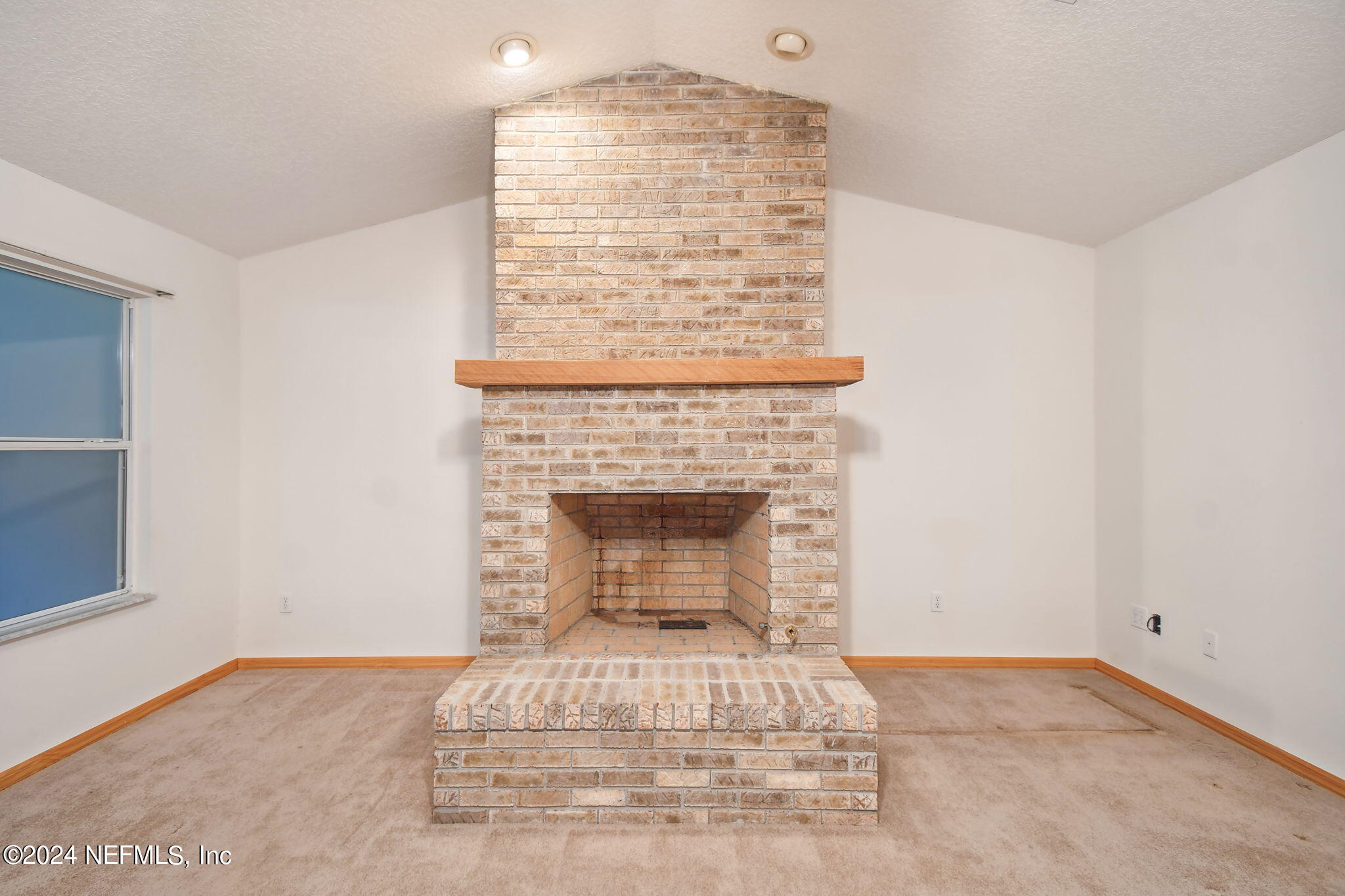 36068 J W Elliott Road Callahan, FL 32011 - Photo 13 of 54 a view of empty room with fireplace