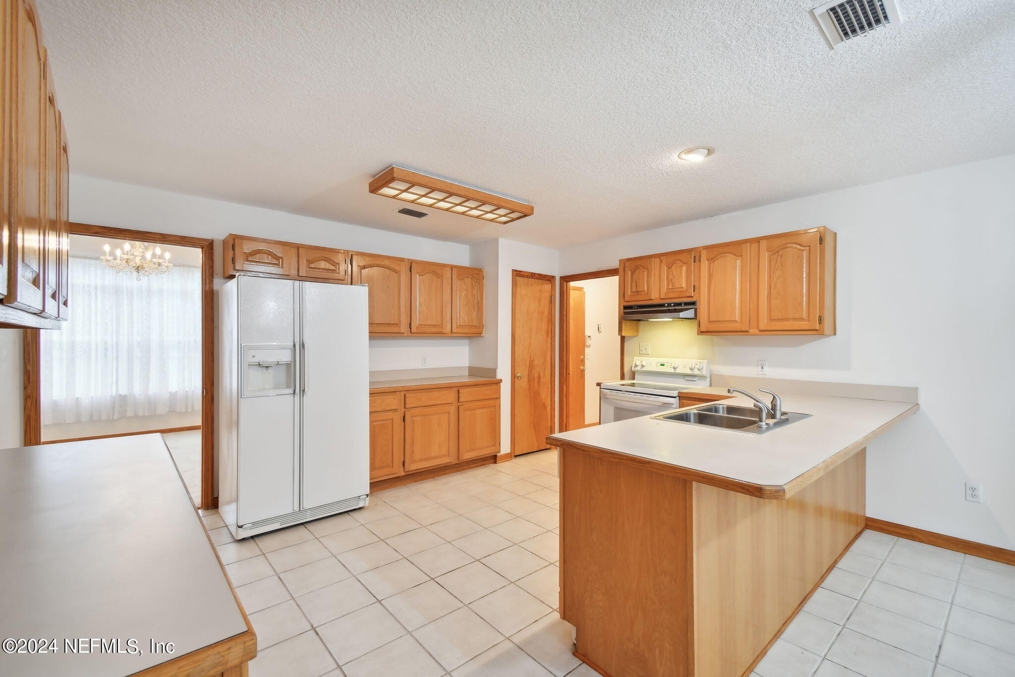 36068 J W Elliott Road Callahan, FL 32011 - Photo 20 of 54 a kitchen that has a sink a stove and a refrigerator