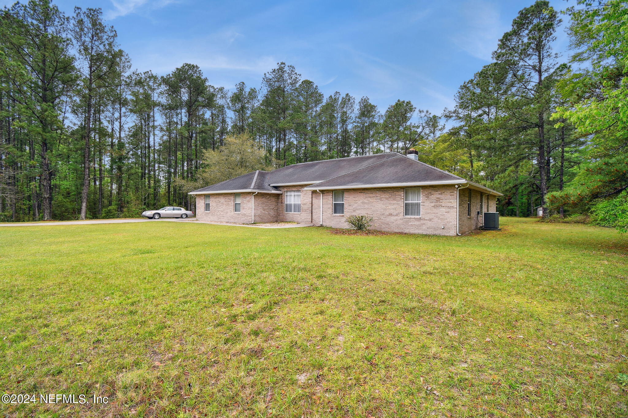 36068 J W Elliott Road Callahan, FL 32011 - Photo 2 of 54 a front view of a house with yard and tree