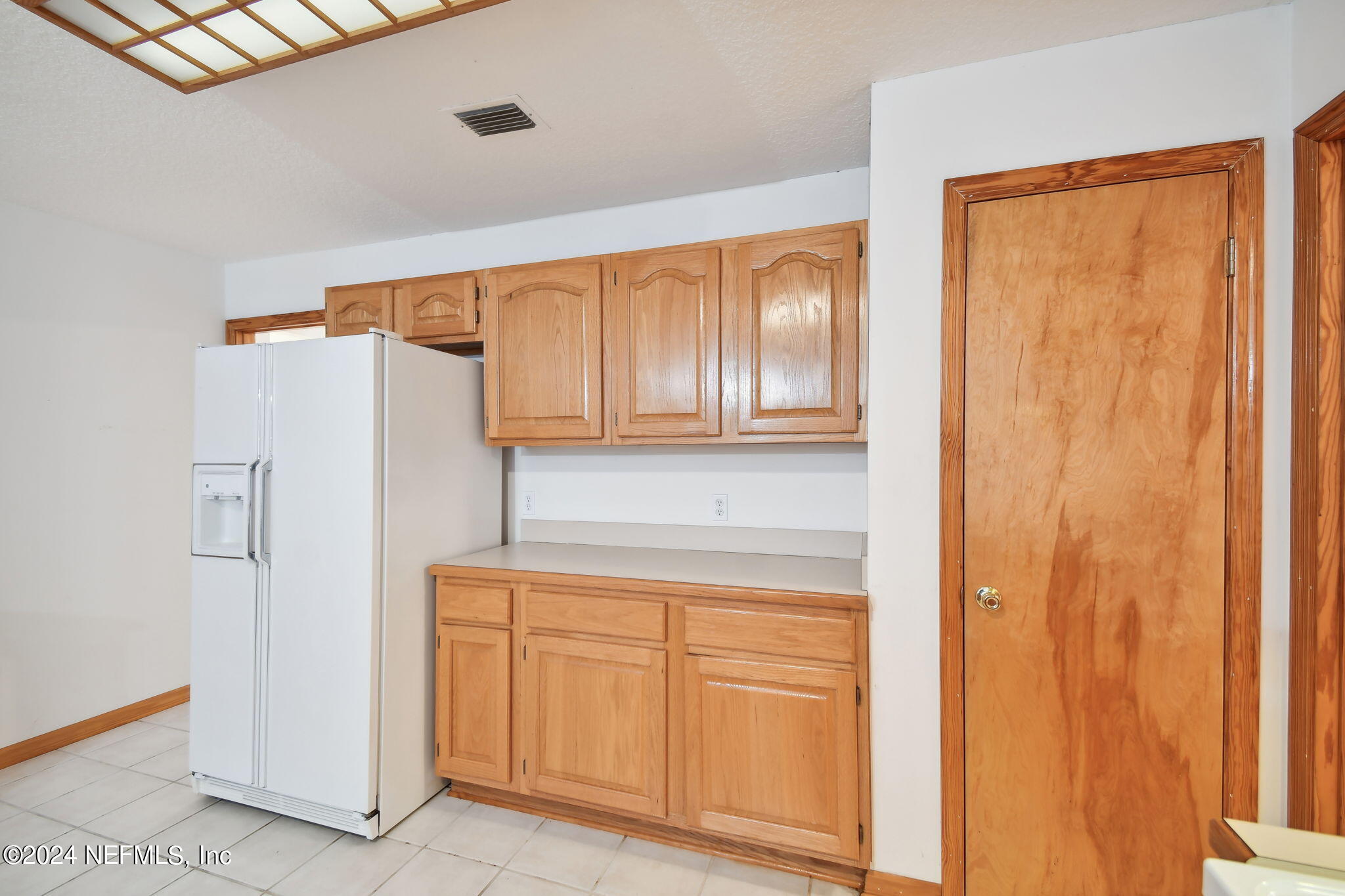 36068 J W Elliott Road Callahan, FL 32011 - Photo 26 of 54 a kitchen with cabinets and a refrigerator