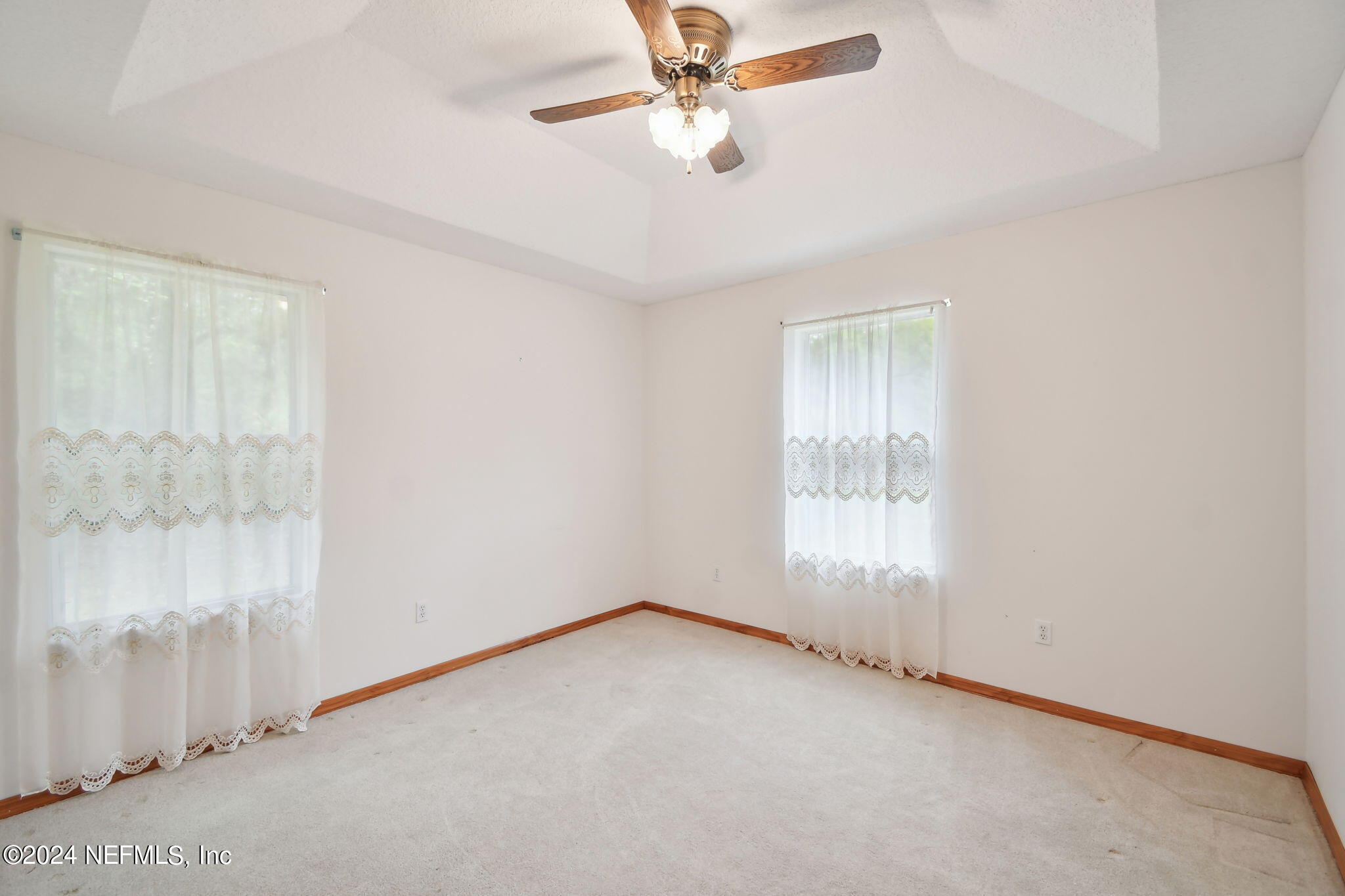36068 J W Elliott Road Callahan, FL 32011 - Photo 30 of 54 an empty room with a window and a fan