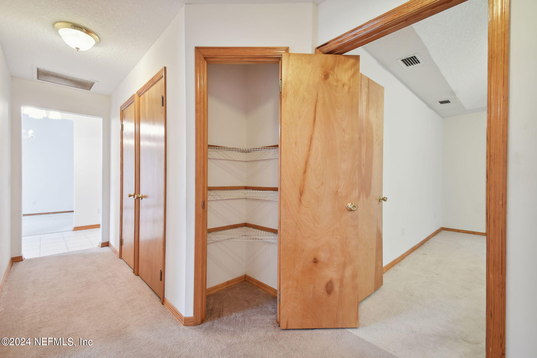 36068 J W Elliott Road Callahan, FL 32011 - Photo 34 of 54 a view of a bathroom with a walk in closet and wooden floor