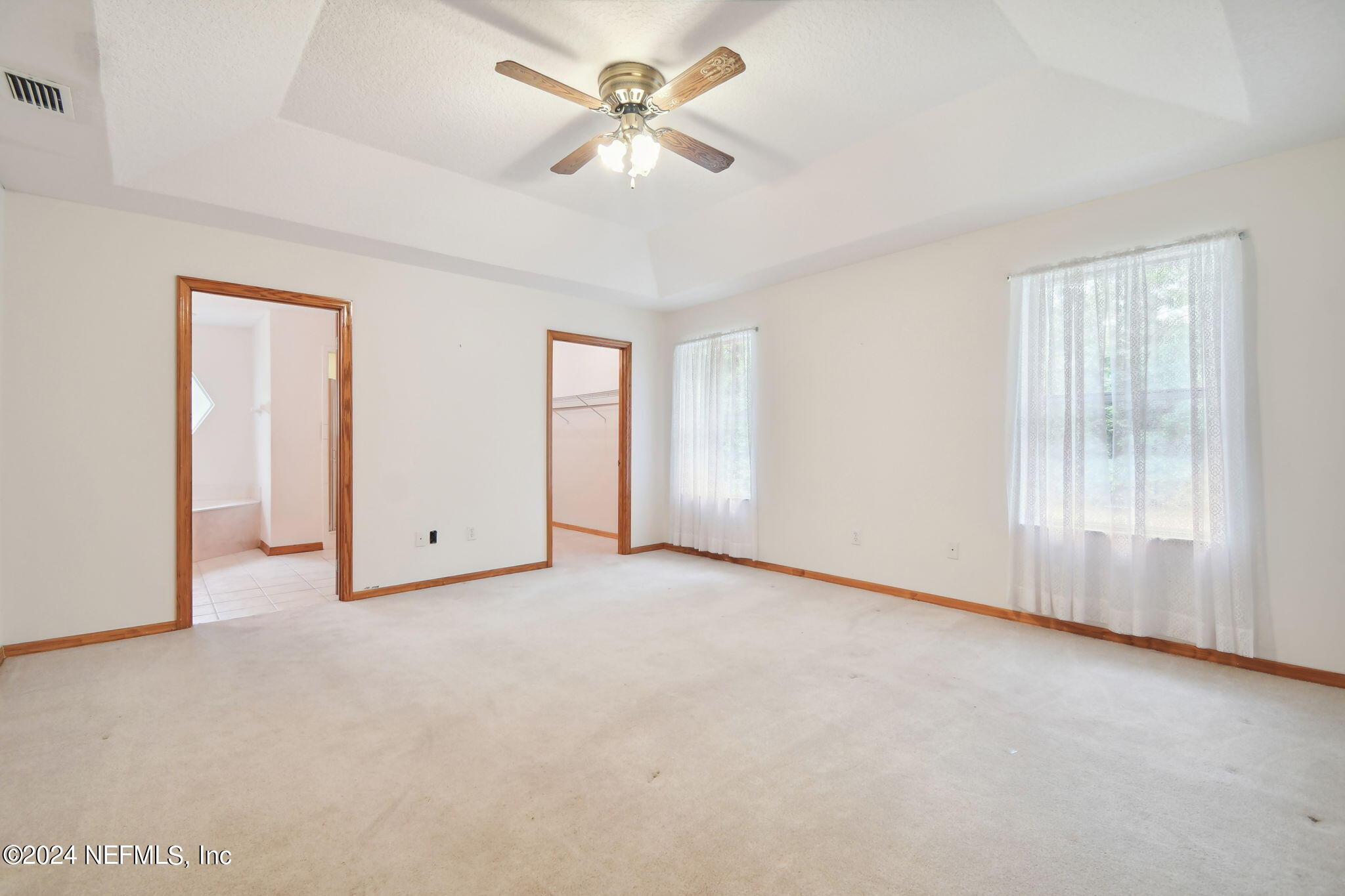 36068 J W Elliott Road Callahan, FL 32011 - Photo 37 of 54 an empty room with chandelier fan and windows