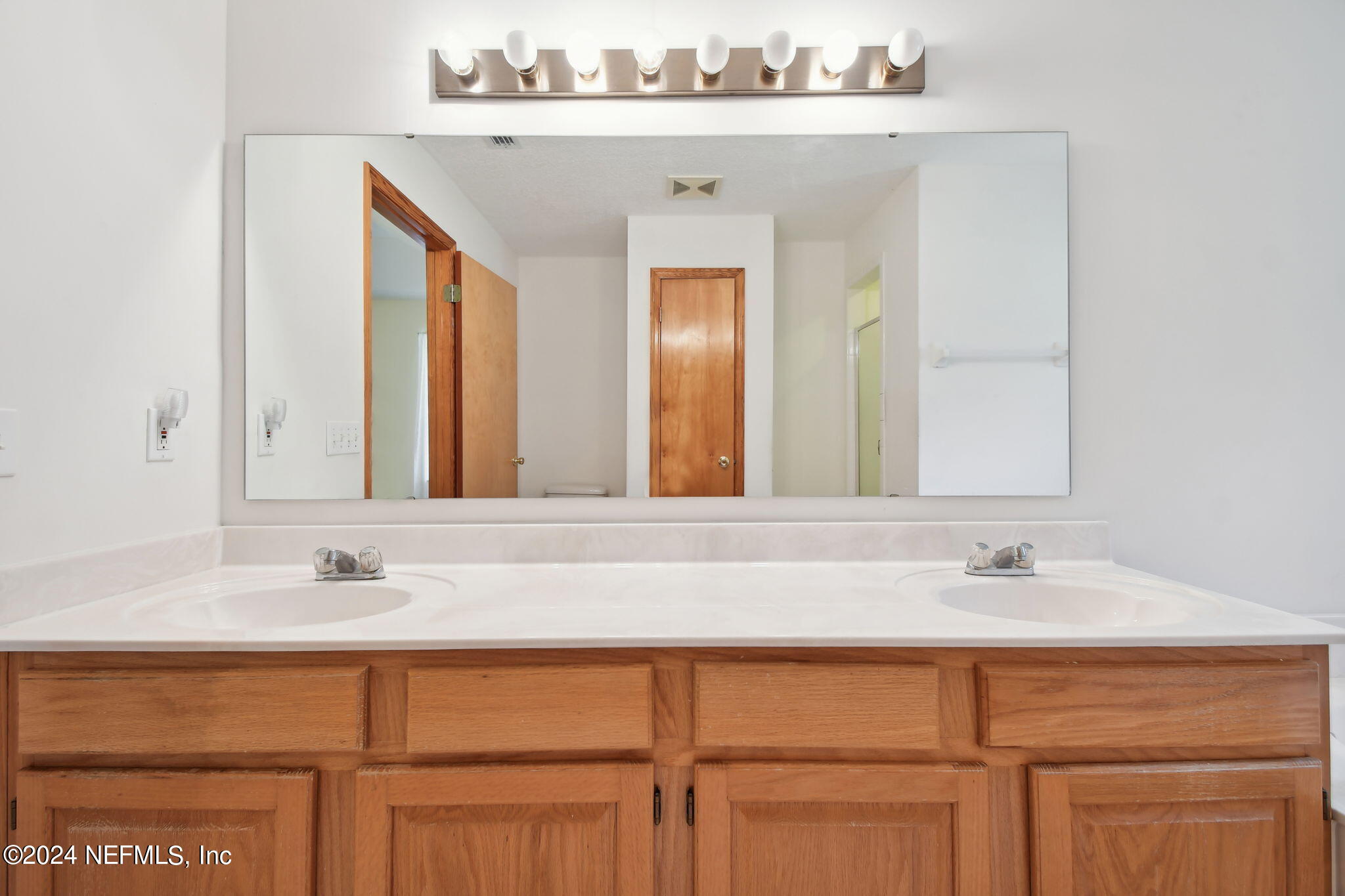 36068 J W Elliott Road Callahan, FL 32011 - Photo 41 of 54 a sink with a mirror and a vanity