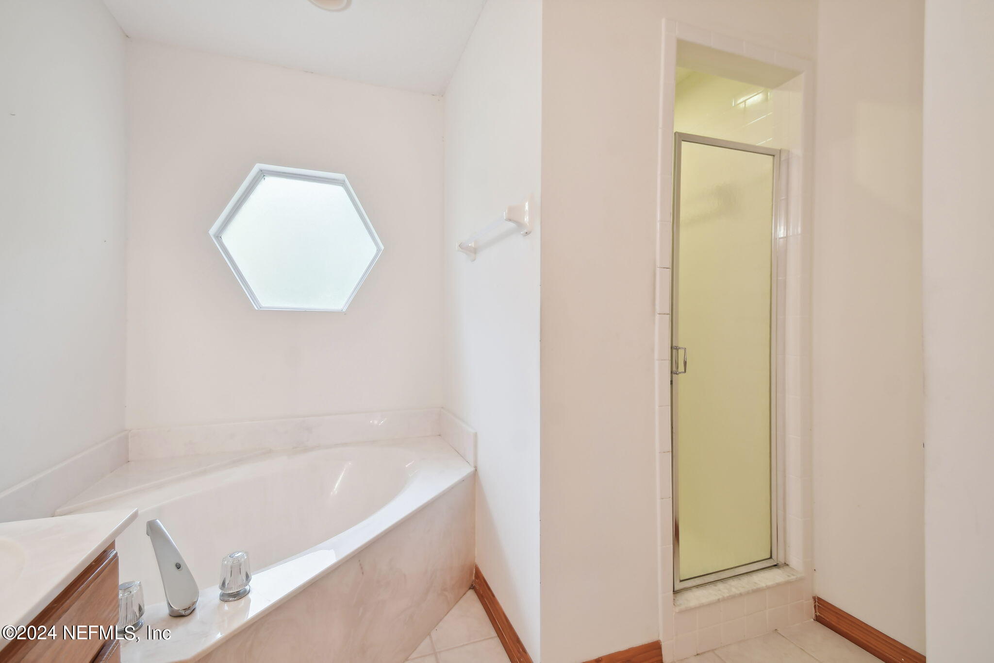 36068 J W Elliott Road Callahan, FL 32011 - Photo 42 of 54 a bathroom with a bathtub and a shower