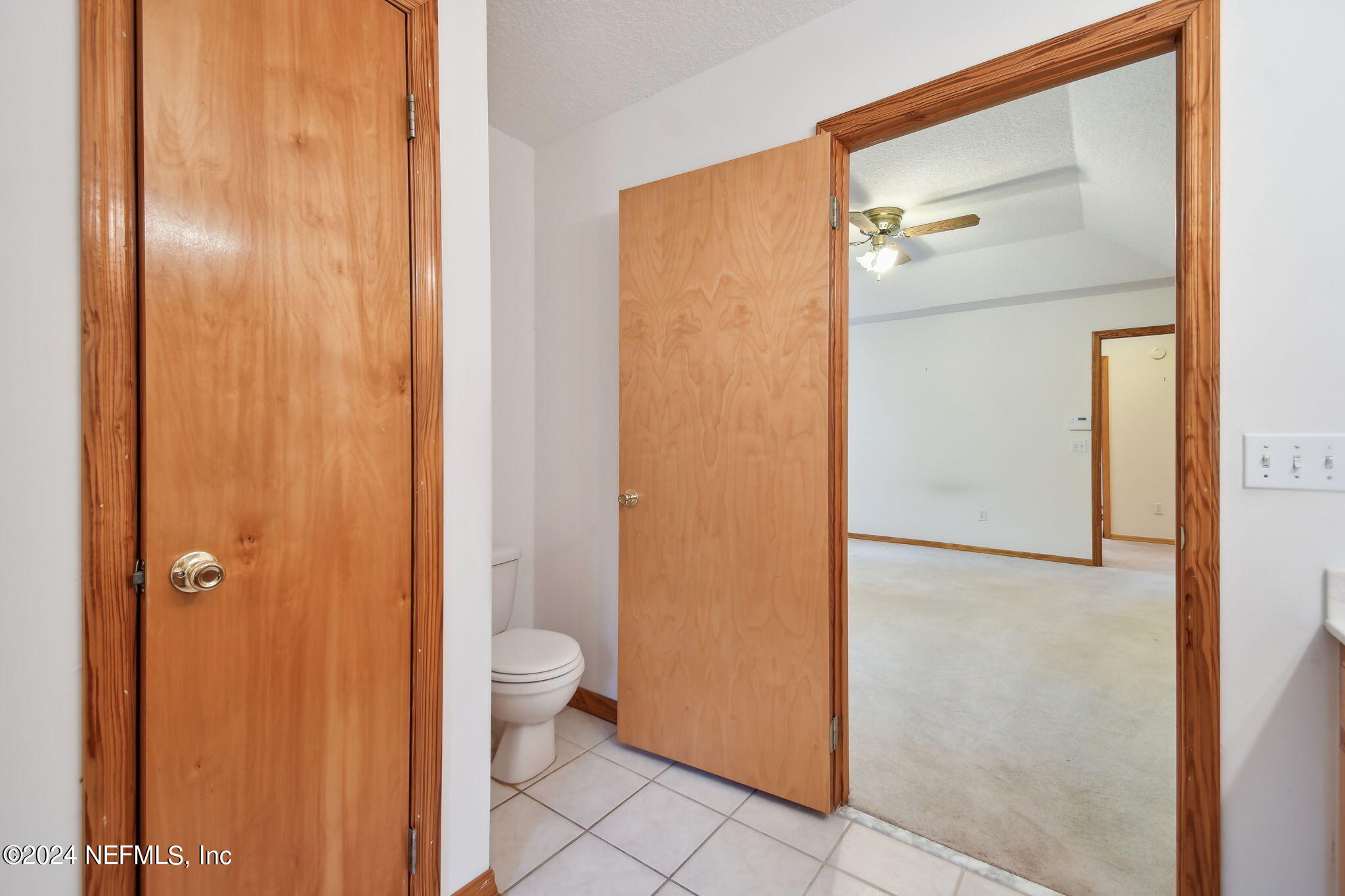 36068 J W Elliott Road Callahan, FL 32011 - Photo 43 of 54 a bathroom with a granite countertop shower a toilet and a sink