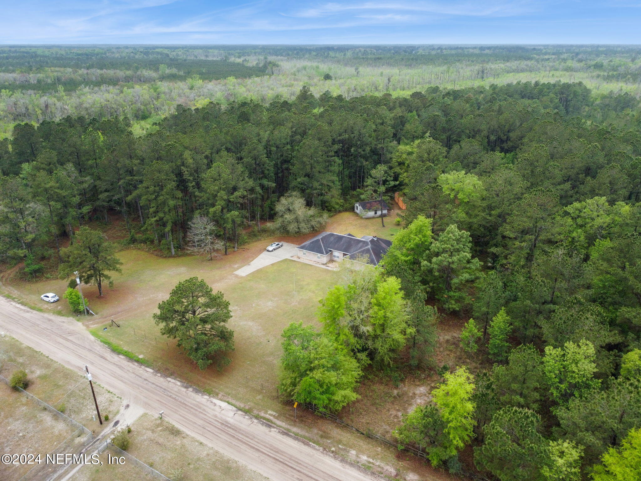 36068 J W Elliott Road Callahan, FL 32011 - Photo 52 of 54 a view of a lake with a yard