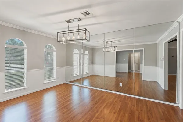 a view of a room with wooden floor swimming pool and windows